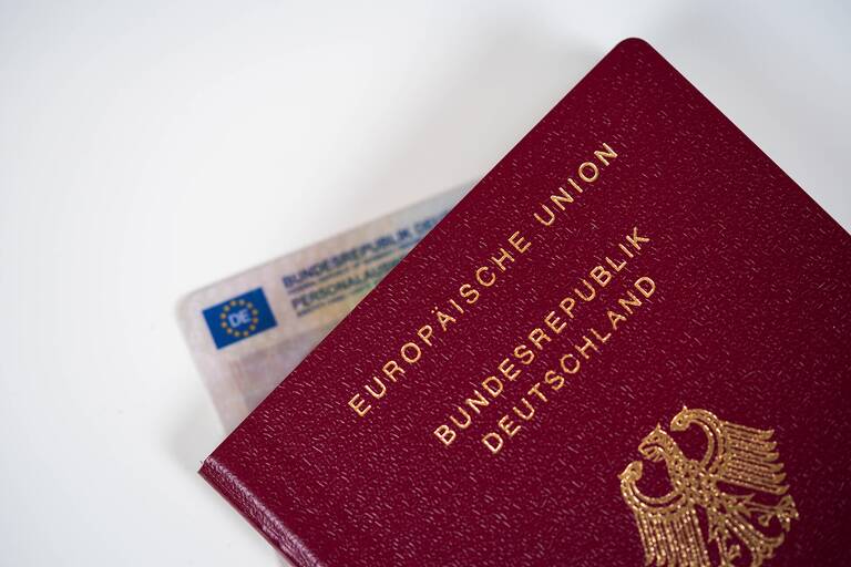 Deutscher Reisepass der Europäischen Union liegt teilweise überdeckt von einem Personalausweis.